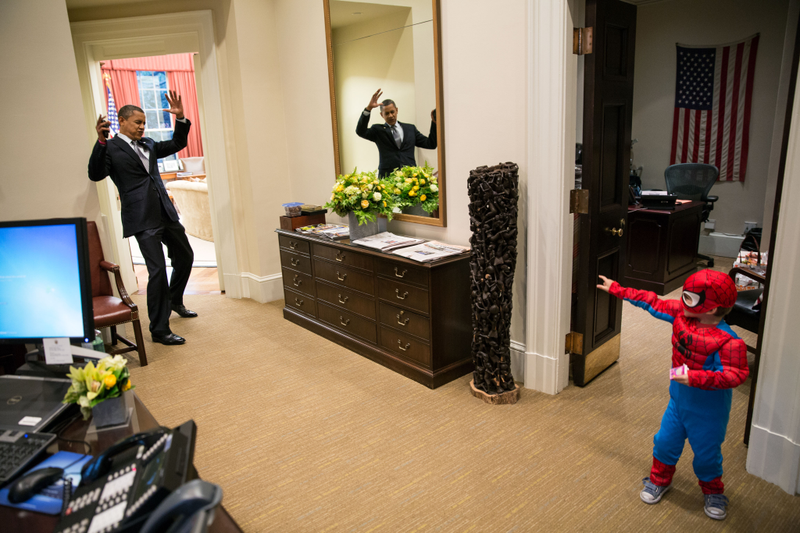 President Barack Obama pretends to be caught in Spider-Man’s web as he greets 3-year-old Nicholas Tamarin just outside the Oval Office on Oct. 26, 2012, in Washington, D.C. Spider-Man had been trick-or-treating for an early Halloween with his father, White House aide Nate Tamarin, in the Eisenhower Executive Office Building. (Pete Souza/the White House via Getty Images)